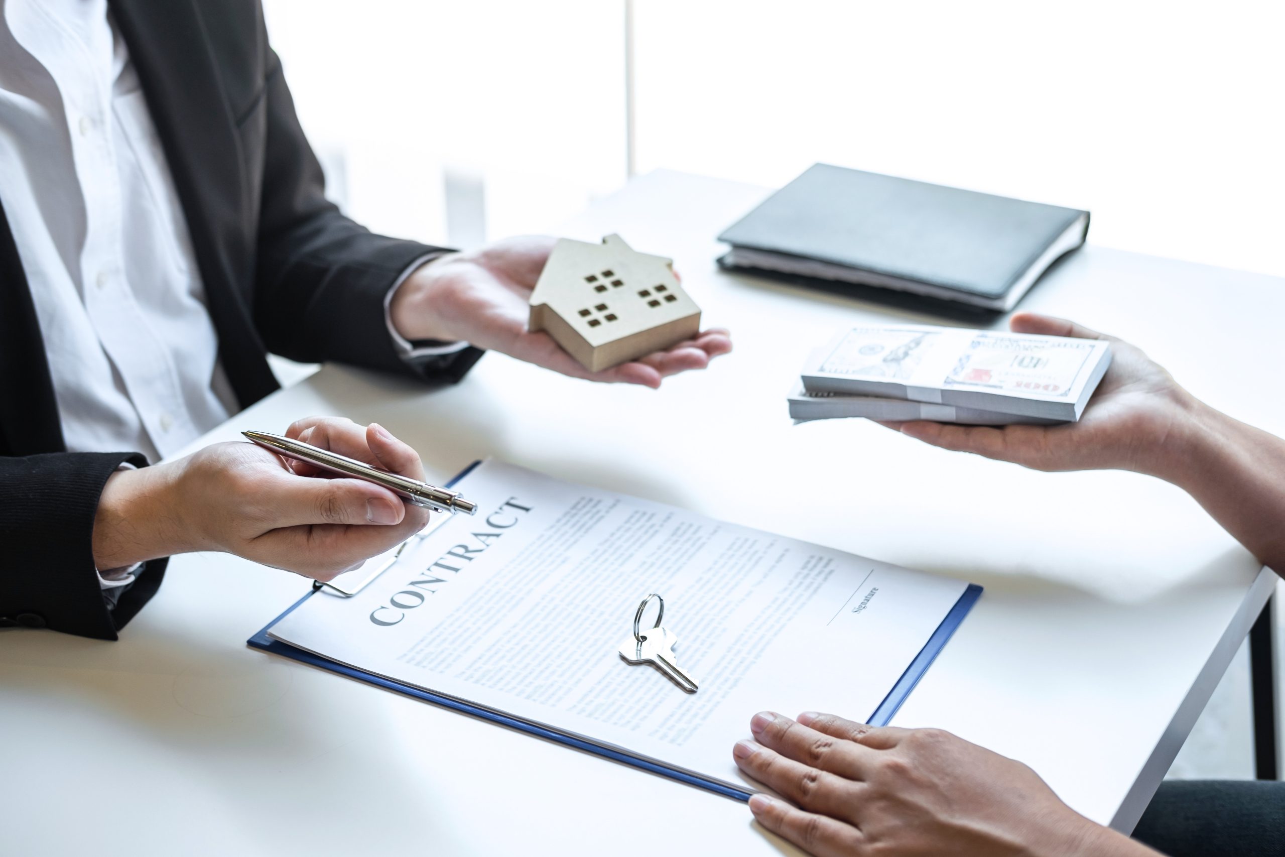 Estate agent sending house model to client after signing agreeme