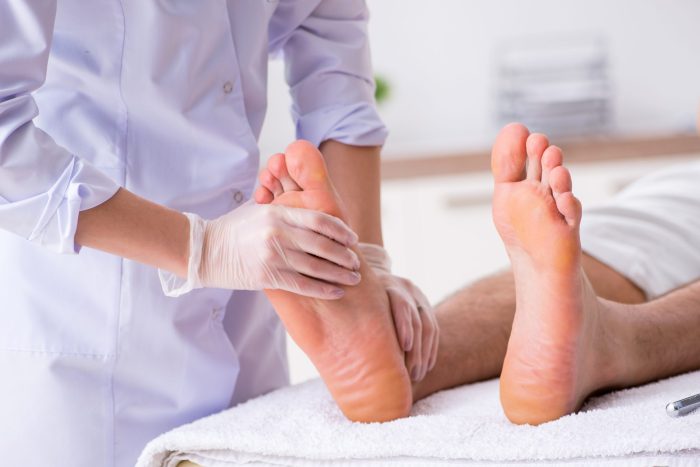 Podiatrist treating feet during procedure